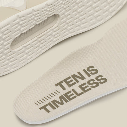 Close-up of a shoe sole with 'TEN IS TIMELESS' text on a beige background